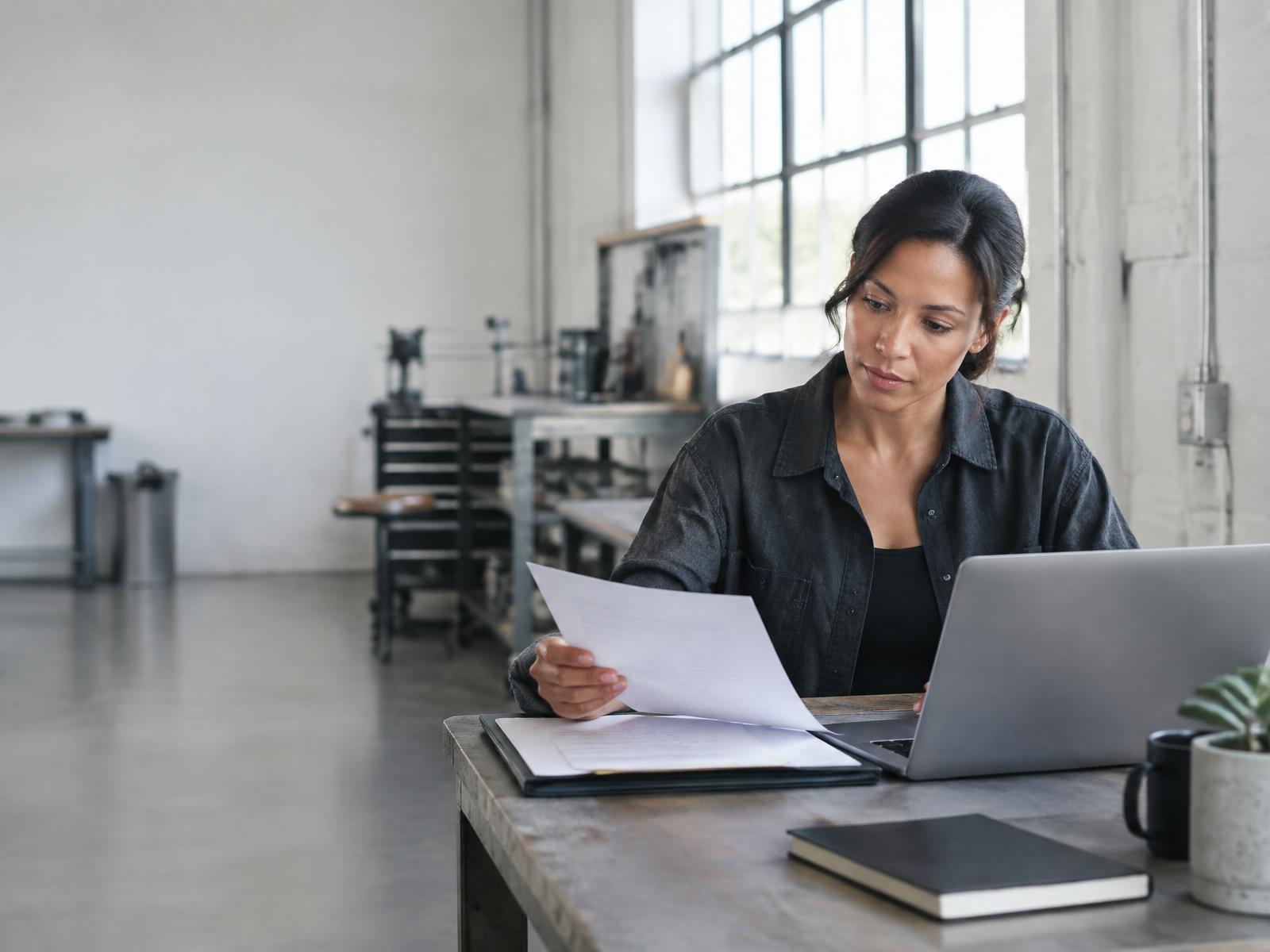Business owner reviewing documents at her workshop